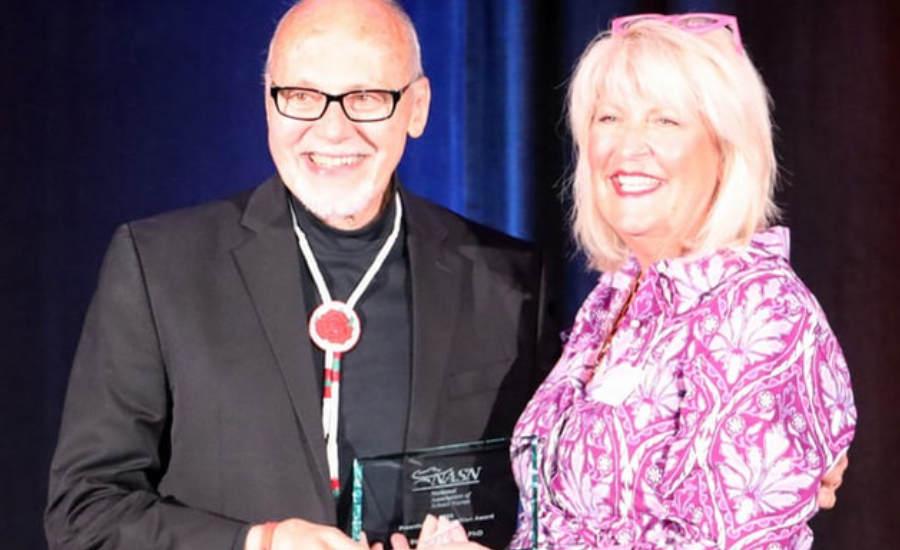 Dr. Kate King presenting Steve with the 2025 National Association of School Nurses President's Recognition Award